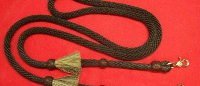 Poly roping rein with coffee colored rawhide braided knots and horsehair tassles